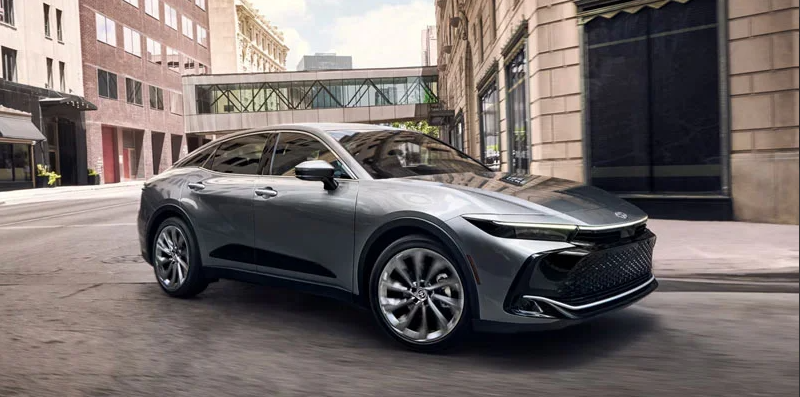A Silver 2026 Toyota Crown making a turn on a city street.